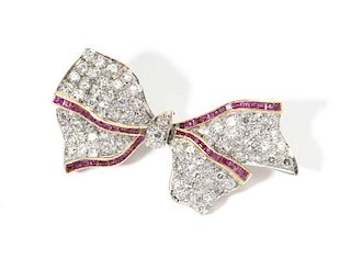 A diamond, ruby, platinum and gold bow brooch