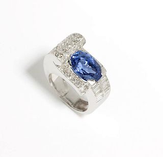 A sapphire, diamond and platinum scroll ring
