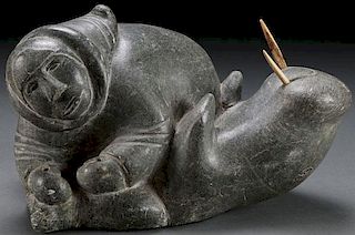 A SOAPSTONE CARVED INUIT FIGURE WITH WALRUS