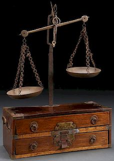 A BRONZE SCALE MOUNTED ON A WOOD BOX