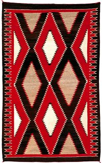 Vibrant Navajo regional rug in red, brown, and ivo