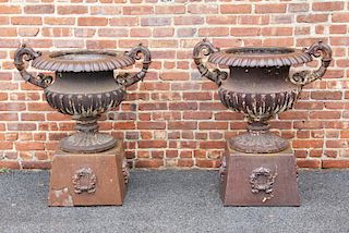 Pair Of Antique Cast Iron Urns On Stands .