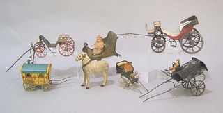 Seven tin cart and carriage toys, early /mid 20th.