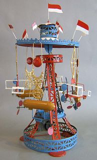 Muhler & Kadater painted tin go-round toy, with ze