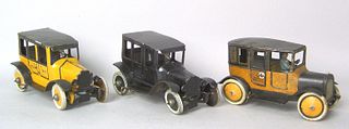 Two painted tin Yellow taxis, ca. 1930, together w