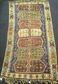 Kilim rug, ca. 1920, with 7 medallions on a blue f