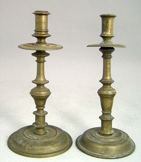 Two similar Continental brass candlesticks, mid 18