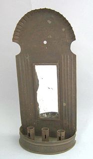 Tin wall sconce,19th c., with a mirrored back abov