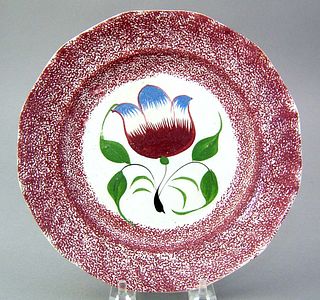 Red spatter plate, 19th c., with tulip decoration,