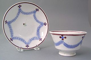 Spatter cup and saucer, 19th c., in a drape patter