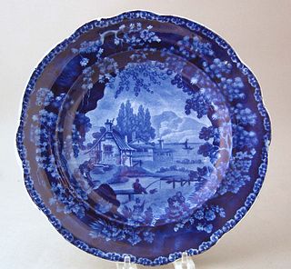 Historical blue plate with cottages along the rive