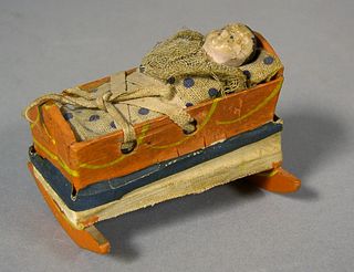 Doll in cradle squeak toy, 19th c., with polychrom