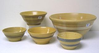Five yelloware bowls, largest - 8" h., 16 1/2" dia