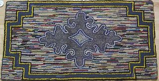 Three American hooked rugs with geometric decorati