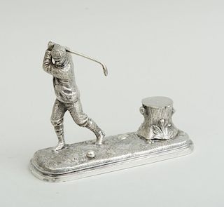 SILVERED METAL INKSTAND WITH FIGURE OF A GOLFER AND GLASS- LINED "TREE TRUNK" WELL