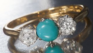 A TURQUOISE AND DIAMOND THREE STONE RING