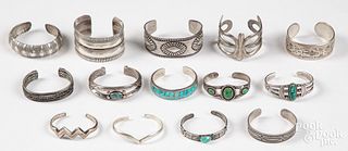 Fourteen silver cuff bracelets