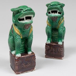 Pair of Chinese Green, Aubergine and Ochre Glazed Porcelain Seated Buddhistic Lions
