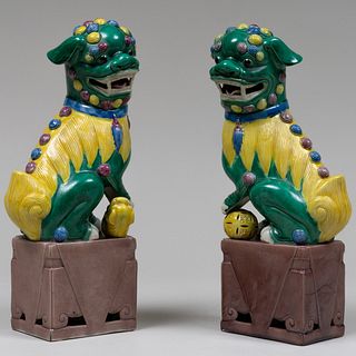 Pair of Chinese Aubergine, Green and Ochre Glazed Porcelain Models of Buddhistic Lions with Puppy and Ball