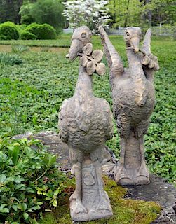 A pair of carved sandstone Liver birds, or cormorants, one with wings folded, the other with wings outstretched