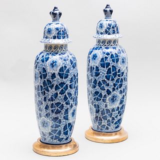 Pair of Delftware Vases and Covers Mounted on Later Giltwood Bases 