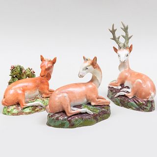 Three Staffordshire Pottery Models of Recumbent Deer 