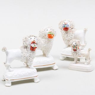 Four Staffordshire Models of Poodles with Baskets 