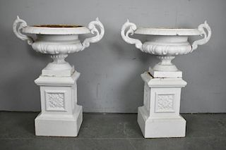 Pair of Cast Iron Urns on Stands.