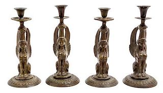 * A Set of Four Empire Style Cast Metal Candlesticks Height of tallest 10 1/4 inches.