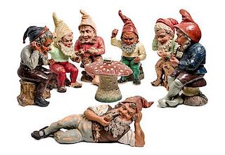 * A Collection of Seven German Painted Terra Cotta Gnomes Height of tallest 23 inches.