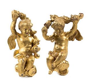 * A Pair of Continental Giltwood Putti Height 27 inches.