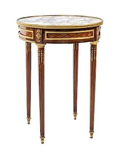 A Louis XVI Style Gilt Bronze Mounted Mahogany and Parquetry Bouillotte Table Height 29 1/2 x diameter of top 22 inches.