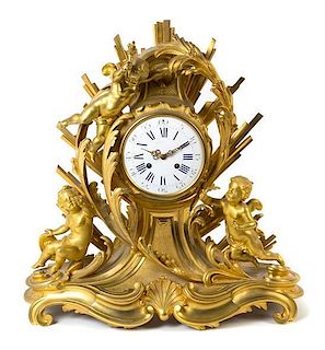 * A Napoleon III Gilt Bronze Mantel Clock Height 23 inches.