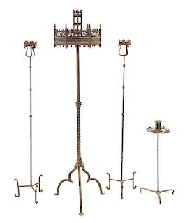 * A Group of Four Continental Iron Torcheres Height of tallest 65 inches.