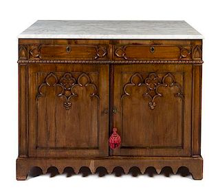 A Gothic Revival Walnut Cabinet Height 35 x width 44 1/2 x depth 21 inches.
