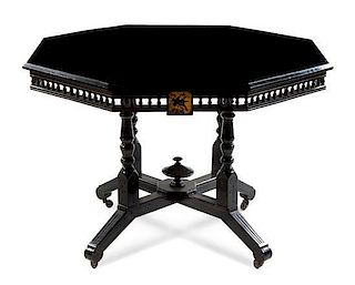 An Aesthetic Movement Parcel Ebonized and Painted Center Table Height 28 x width 41 1/2 inches.