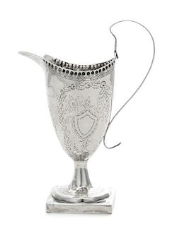 * A Georgian Silver Creamer, , of helmet form and raised on a square base, the body engraved to show ribbons and foliate deco