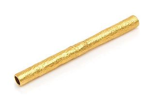 A 22 Karat Yellow Gold Straw, 20th Century, of cylindrical form with a stippled finish.
