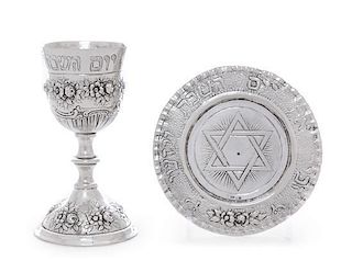 A German Silver Kiddush Cup and Underplate, Early 20th Century, the bowl rim chased with Hebrew inscription and two grape bun