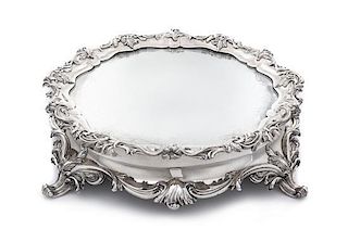* A Rococo Style Silver-Plate Table Plateau, 19th/20th Century, of shaped circular form, the rim worked to show floral and fo