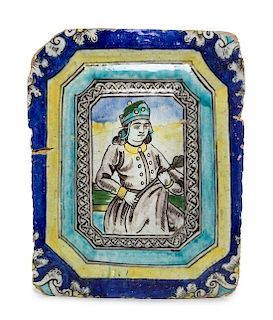 * A Qajar Molded Pottery Tile Length 17 3/4 inches.