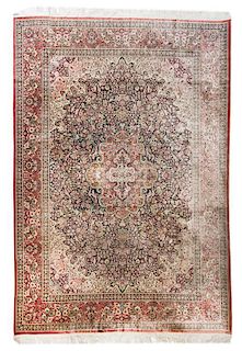 * A Persian Wool and Silk Rug 11 feet 6 inches x 8 feet 7 inches.