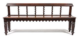 A Jacobean Revival Hall Bench Width 65 inches.