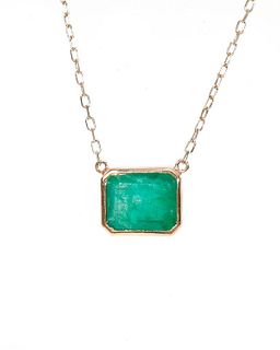 An emerald and 14k gold necklace