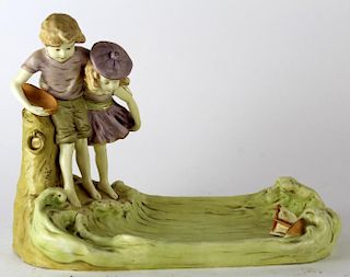 Porcelain statue depicting boy and girl