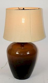 Amber glass wine bottle mounted as lamp