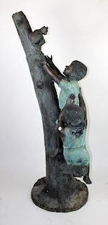 Bronze statue of children climbing a tree