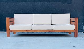 Teak Wood 3 Seater Sofa With Cream Colored Cushions.
