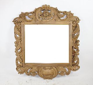 Rococo style carved mirror with focal cherub.  Natural finish.