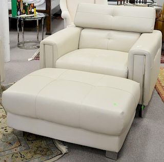 Modern tan leather armchair with ottoman having chrome feet and frame.